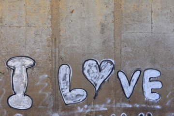 inscription love on a concrete wall