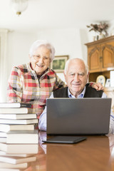 Senior couple working with Laptop at home