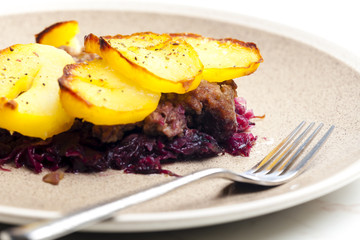 potatoes baked with pork minced meat and red cabbage