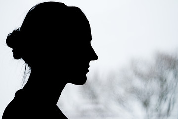 Lady Silhouette with blurry tree background