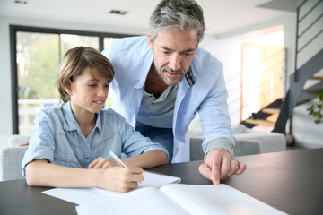 Father helping son with homework