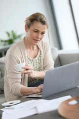 Middle-aged woman working from home on laptop