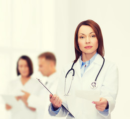 calm female doctor with clipboard