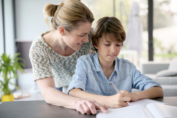 Mother helping kid with homework