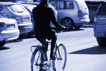 Man on bicycle in evening traffic