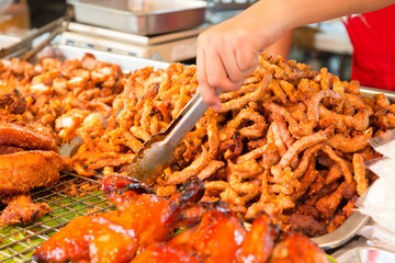 close up of cook hands and snacks at street market