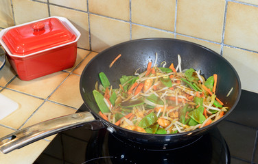 prawns and cooked vegetables in a wok