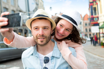 Obraz premium Young couple on holidays taking selfie