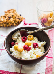 cottage cheese with fresh raspberries in a clay plate, granola b