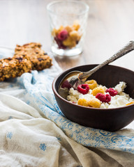 cottage cheese with fresh raspberries in a clay plate, granola b