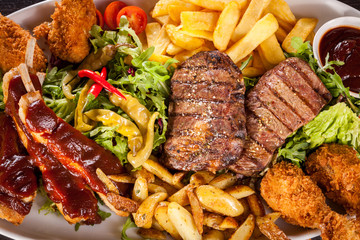 Platter of mixed meats, salad and French fries