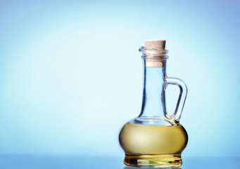 Obraz na płótnie Canvas Olive oil on a blue background