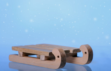 Sled on snowy background