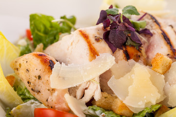 tasty fresh caesar salad with grilled chicken and parmesan