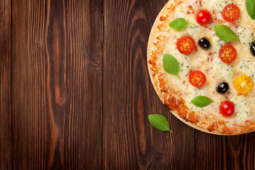 Italian pizza with cheese, tomatoes and basil
