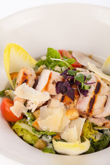 tasty fresh caesar salad with grilled chicken and parmesan