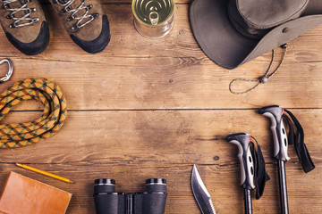 Equipment for hiking on a wooden floor background - obrazy, fototapety, plakaty