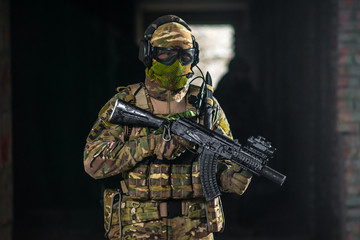 Airsoft strikeball player in military soilder uniform