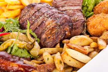 Platter of mixed meats, salad and French fries
