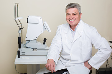 portrait of handsome elderly eye doctor