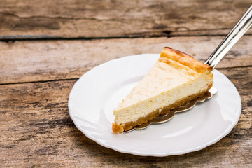 Fresh cheesecake on wooden table.