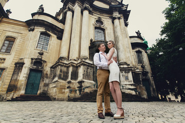Fototapeta na wymiar couple walk in old town lviv,kissing,loving. On the roof