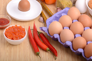 eggs on eggshell and red pepper, red caviar and tomato