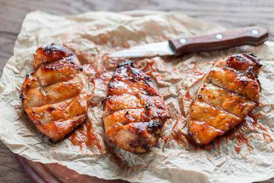 Grilled chicken breasts in hot mango sauce