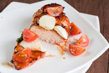 Grilled chicken steak with mozzarella and cherry tomatoes