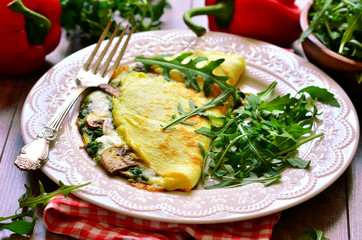 Omelet stuffed with spinach and mushrooms.