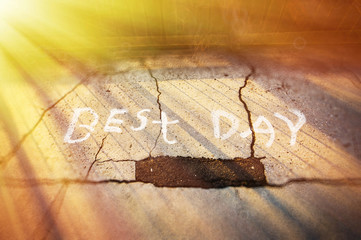 Best Day written on road side with beautiful sun ray