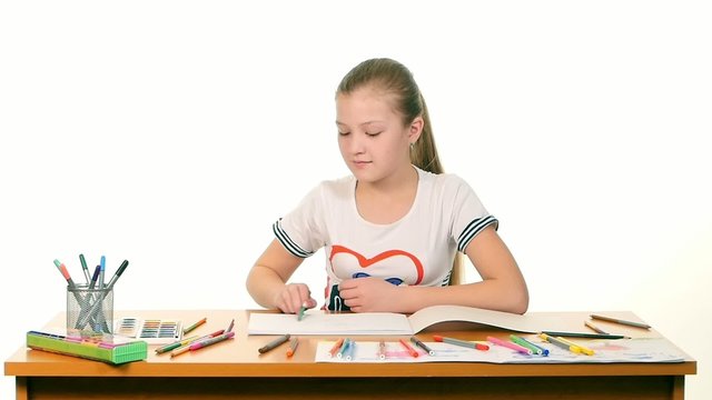 Blonde, cute girl paints colors on white background, slow motion