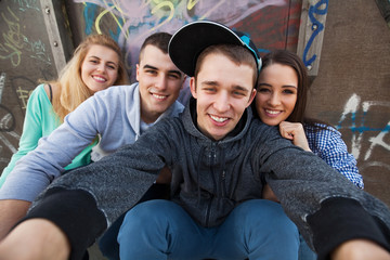 Four teenagers posing for a selfie