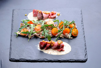 Appetizer with mushrooms, meat and tomatoes