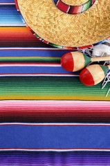 Mexican background serape striped blanket with sombrero maracas Mexico cinco de mayo festival vacation photo