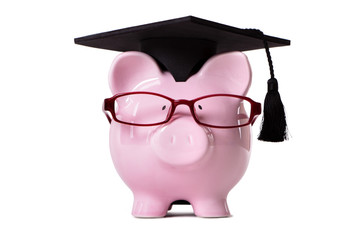Student Piggy Bank or piggybank wearing graduate cap and glasses isolated on white background photo