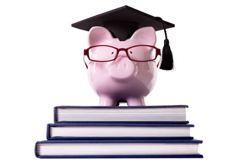 Student Piggy Bank or piggybank wearing graduate cap and glasses isolated on white background photo