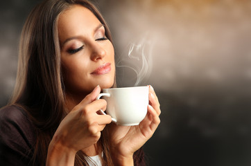 Beautiful young woman with cup of coffee