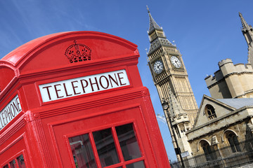 Fototapeta na wymiar London red telephone box booth with westminster houses of parliament building and Big Ben clock tower in the background photo