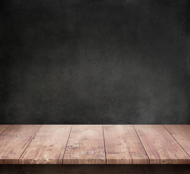 Wood table with dark concrete texture background