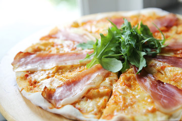 Pizza margherita with parma ham and rocket
