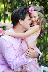 Fototapeta premium Portrait of young father and his cute daughter hug and love 