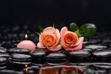 Beautiful orange rose with candle and therapy stones