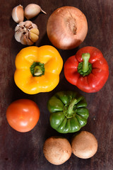 Fresh vegetables and ingredients for pizza on wooden background