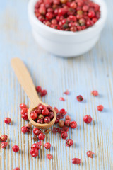 red peppercorns on wooden table