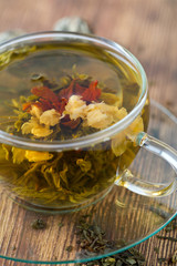 exotic green tea with flowers in glass cup