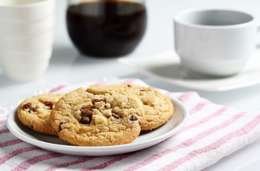 the chocolate and macadamia cookies on dish set for coffee break