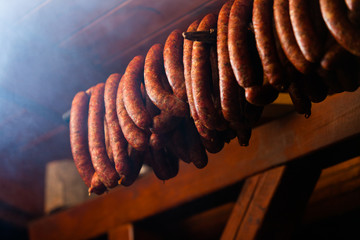 Traditional food. Smoked sausuages in smokehouse.