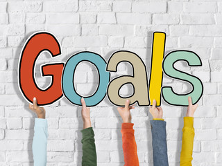 Group of Hands Holding Word Goals Concept