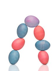 Seven colored eggs form an arch on white